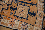 Distressed Kurd runner's geometric patterns with tangerine, navy, and ivory hues.