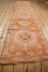 Hand-knotted distressed Kurd runner texture, with tangerine orange and beige geometric patterns.