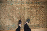 Faded beige and dusty mint green Herati pattern on a vintage Hamadan rug.