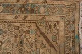 Distressed vintage Hamadan rug corner, with beige, mint green Herati motifs, and faint foundation showing.