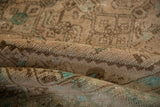 Distressed Hamadan rug's worn pile, showing faint foundation, beige, and dusty mint green.