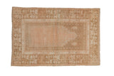 Vintage distressed Oushak prayer rug with a dusty rose mehrab and a wide beige floral border.