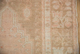 Even wear across the knot heads and low pile texture of a distressed Oushak rug.