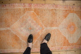 Distressed vintage Kurd runner pile, highlighting pale rust, tangerine, and faded magenta.