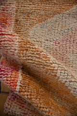 Textured pile of a vintage distressed Kurd rug runner, with abrashed rust and faded magenta.