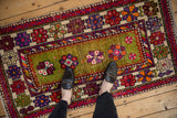 Vintage Oushak rug with unusual moss green field, floral patterns, abrash, and wear.