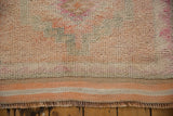 Kurd runner's textured short pile with cantaloupe, faded magenta, striped flat-weave, fringe.