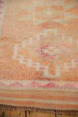 Vintage Distressed Kurd rug pile with geometric pattern in cantaloupe, ivory, and faded magenta.