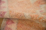Distressed hand-knotted pile texture of the vintage Kurd runner, cantaloupe and ivory.