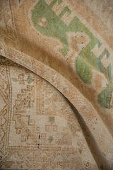 Distressed Kars carpet pile showcasing dusty emerald green geometric motifs and even wear.