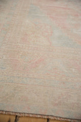 Close-up of the distressed Oushak carpet showing even wear to the hand-knotted pile.