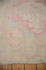 Distressed low-pile texture of a vintage Turkish rug in pale red, denim blue, and sand.