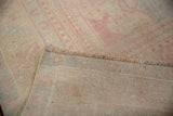 Corner view of a vintage Oushak showing the hand-knotted back and machine-wrapped selvage.