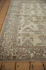 Distressed Oushak rug displaying cream, dusty rose, and silver germinating plant motifs.