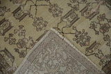 Detailed view of hand-knotted Oushak rug's foundation, fringe, and softened floral pattern.