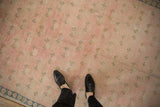 Distressed pink and ivory Sparta rug with allover pale green clover and blue border.
