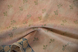 Faded pink and blush pile of distressed Turkish Sparta rug, green clover leaves, blue border.