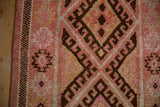 Textured blush pile of vintage Kurd runner with chocolate geometric lattice and checkered border.