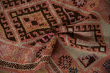 Hand knotted texture of vintage Kurd runner, showcasing blush, magenta, and brown geometric motifs.