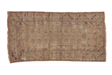 Distressed vintage Oushak runner with faded multi-color pinwheel blossoms and geometric borders.