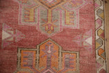 Vintage distressed Kurd rug pile, geometric patterns in dusty cochineal, pale tangerine, silver.