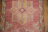 Close-up of distressed vintage Kurd runner border, dusty cochineal, antique ivory geometric pattern.