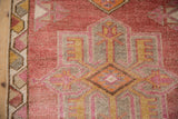 Heavily abrashed pile of the Kurd runner in dusty cochineal with geometric motifs.