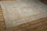 Distressed Oushak rug border and intact side cord selvage with short pile in sand and coffee brown.