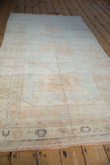 Angled view of the full distressed Oushak runner with a soft, sun-faded pastel design.