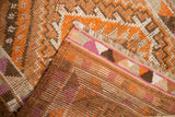 Distressed Kurd runner's worn geometric pile and striped woven foundation in orange, brown, pink.