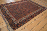 Antique Afshar rug with madder red field, staggered navy and ivory boteh pattern, even wear.