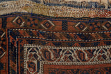 Antique Afshar rug kilim showing varied mending threads, above a geometric red, navy, ivory border.