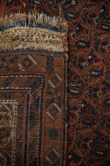 Antique Afshar rug: close-up of hand-knotted foundation, storied kilim repairs, and tattered fringe.