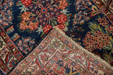 Hand-knotted Qazvin rug corner revealing tight ivory foundation and intricate vine border.