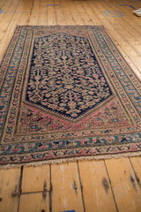 Vintage Hamadan rug corner: navy blue field with pink blossoms, light blue and beige borders.