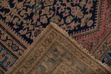 Hand-knotted vintage Hamadan rug pile showing navy, pink floral pattern and visible foundation.