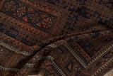 Detailed view of the reciprocating wave and pawn design motifs on a vintage Belouch rug.