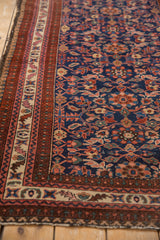 Vintage Malayer rug border, deep indigo field with allover florals, and fine wear.