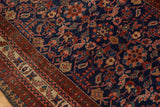 Vintage Malayer rug's deep indigo floral field with traditional geometric border in red and beige.