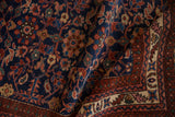Hand-knotted Vintage Malayer rug displays deep indigo field with allover floral patterns, ruby red border.