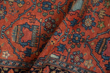 Vintage Lilihan rug fold, intricate blue and green potted plant motifs on brick red hand-knotted pile.