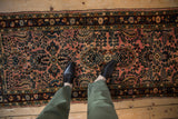 Distressed Persian Lilihan runner, soft raspberry and navy floral patterns underfoot.