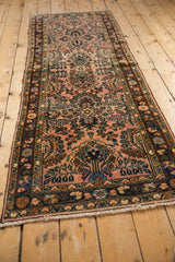 Vintage distressed Lilihan runner's hand-knotted floral sprays; dusty raspberry, navy, and beige tones.
