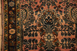 Distressed Lilihan rug runner showing side border and allover floral sprays on dusty raspberry and navy.