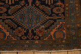 Vintage Mehriban rug corner with geometric field, boteh border, fringe, and even wear.