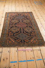 Hand-knotted Mehriban rug corner, displaying ram's horn motif and intact fringe.