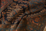 Vintage Mehriban rug's worn pile, with navy, madder red, and sky blue patterns.
