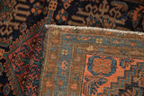 Vintage Mehriban rug's hand knotted foundation and secured side, revealing madder red border.