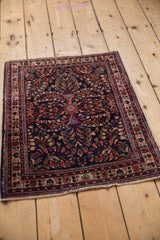 Vintage American Sarouk rug corner: raspberry floral sprays on its rare dark blue ground.