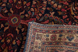 Vintage Sarouk rug detail: hand-knotted dark blue ground with floral sprays and woven back.